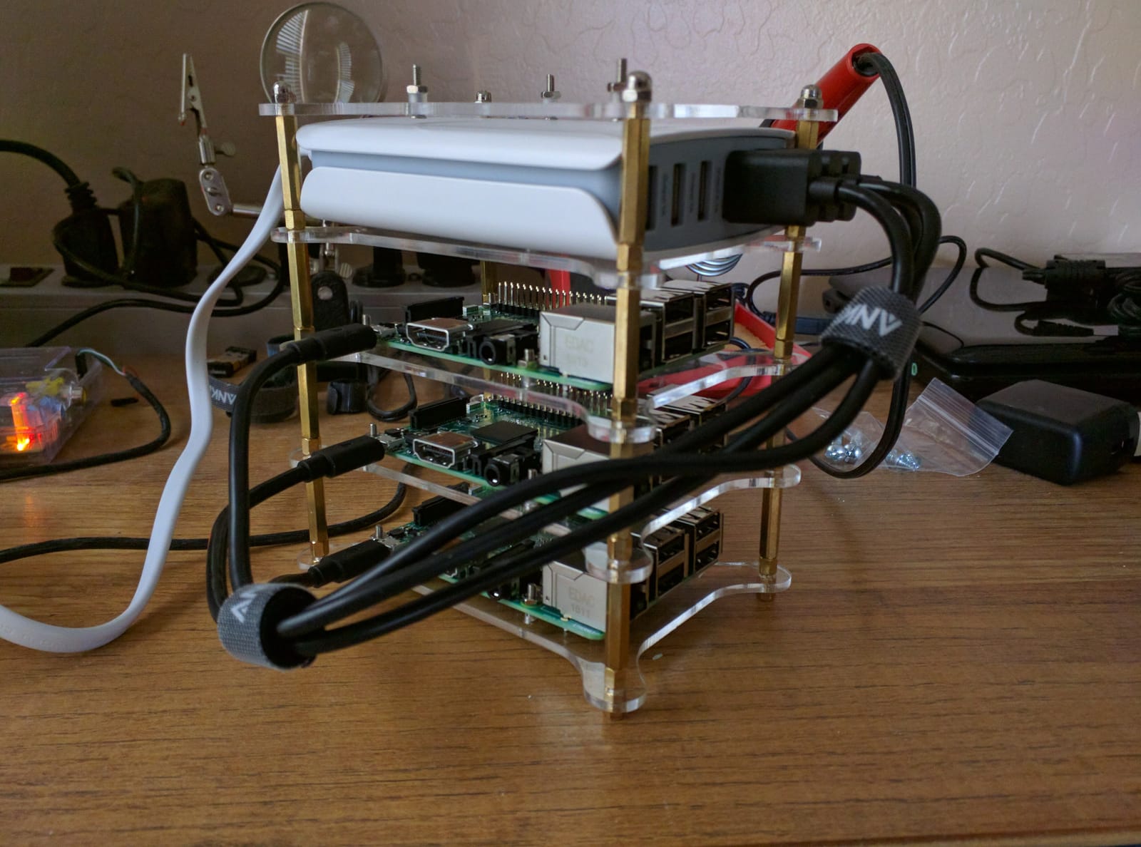 A stack of Raspberry Pi boards mounted on an acrylic tower frame, wired together for a Docker Swarm cluster