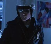 The T-1000 from Terminator 2 dressed as a motorcycle police officer, wearing a helmet and mirrored sunglasses